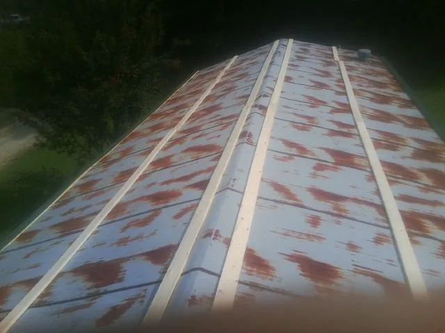 Rusted metal roof panels with new wood purlins before replacement — Storm Damage Roof Repair in Vancleave by Roofing Brothers